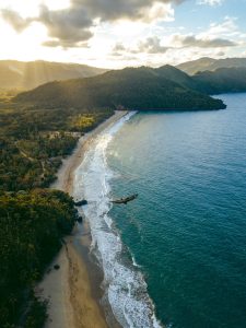 A beach and forested mountains in the Dominican Republic