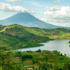 Image of a mountain in the background and sloping hills and a river in the fore and midground of the Rwandan landscape