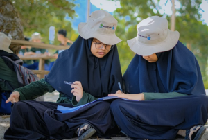 Two girls study together from Health in Harmony in Indonesia