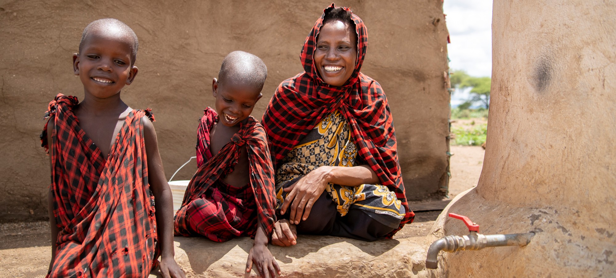 mom and children at rainwater harvesting system